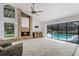 Relax by the brick fireplace in the living room, which also features a sliding glass door to the pool at 2608 Westminster Ter, Oviedo, FL 32765