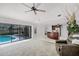 Spacious living room with tile floors and sliding glass doors to the pool at 2608 Westminster Ter, Oviedo, FL 32765