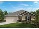 Charming one-story home with a two-car garage, lush lawn, and beautiful landscaping at 2644 Hancock Crossing Dr, Bartow, FL 33830
