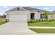 Charming single-story home with a well-manicured lawn, attached two-car garage, and inviting front entrance at 2644 Hancock Crossing Dr, Bartow, FL 33830