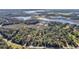 An aerial view of a tree-covered property with a home outline and surrounding natural landscape at 26586 Se Highway 42, Umatilla, FL 32784