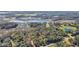 Aerial view showcasing the property's landscape with lakes, lush trees, and proximity to the road at 26586 Se Highway 42, Umatilla, FL 32784