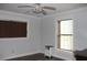 Comfortable bedroom with modern ceiling fan and plenty of natural light from the windows at 26586 Se Highway 42, Umatilla, FL 32784