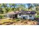 Charming home with a screened porch and lush landscaping surrounded by mature trees at 26586 Se Highway 42, Umatilla, FL 32784