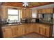 Well-lit kitchen with custom wood cabinets, tiled countertops, and modern appliances at 26586 Se Highway 42, Umatilla, FL 32784