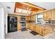 Bright kitchen featuring wood cabinets, black appliances, and ample counter space, ideal for cooking at 26586 Se Highway 42, Umatilla, FL 32784