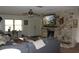 Cozy living room with a stone fireplace, ceiling fan, and comfortable seating, perfect for relaxing at 26586 Se Highway 42, Umatilla, FL 32784