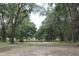 View of property with trees, fencing, and lush greenery at 26586 Se Highway 42, Umatilla, FL 32784