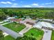 Aerial view of a single-Gathering home, highlighting its long driveway, well-manicured lawn, and serene backyard view at 27714 Lois Dr, Tavares, FL 32778