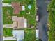 An aerial view of the canal-front homes including boat house and swimming pool at 27714 Lois Dr, Tavares, FL 32778