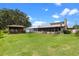Expansive backyard featuring a detached room and porch in a serene setting at 27714 Lois Dr, Tavares, FL 32778