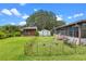 Expansive backyard with shed, summer kitchen, and enclosed porch offering ample space for outdoor enjoyment at 27714 Lois Dr, Tavares, FL 32778