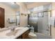 Bathroom with modern faucet, marble countertop, shower, and vanity with storage at 27714 Lois Dr, Tavares, FL 32778