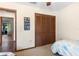 A clean bedroom featuring a closet with bi-fold doors and view to outside at 27714 Lois Dr, Tavares, FL 32778