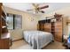 Cozy bedroom featuring natural light, a ceiling fan, and built in shelving at 27714 Lois Dr, Tavares, FL 32778