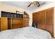 This bedroom features a ceiling fan, shelving units, and closet with bi-fold doors at 27714 Lois Dr, Tavares, FL 32778