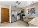 Well-lit kitchen featuring stainless steel refrigerator, stove, and microwave at 27714 Lois Dr, Tavares, FL 32778