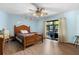 Relaxing bedroom with natural light and sliding glass doors at 27714 Lois Dr, Tavares, FL 32778