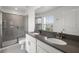 Modern bathroom featuring double sinks, quartz countertops, a large mirror, and a glass-enclosed shower at 3124 Addison Blvd, St Cloud, FL 34771