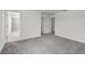 Neutral bedroom showcasing an open floor plan with gray carpet and views of the ensuite bathroom at 3124 Addison Blvd, St Cloud, FL 34771