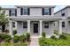 Charming front exterior featuring gray siding, dark shutters, and a welcoming covered porch at 3124 Addison Blvd, St Cloud, FL 34771