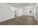Open-concept living room with wood-look floors, and lots of natural light at 3124 Addison Blvd, St Cloud, FL 34771