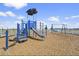 Community playground with a slide, swing set, and wood mulch ground cover on a sunny day at 3124 Addison Blvd, St Cloud, FL 34771