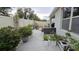 Backyard features a white vinyl fence, planters, and space for gardening at 3202 Timber Hawk Cir, Ocoee, FL 34761