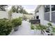 Backyard with concrete patio, white fence, and various potted plants and garden features at 3202 Timber Hawk Cir, Ocoee, FL 34761