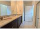 Bathroom featuring double vanity with granite countertop and a walk-in shower at 3202 Timber Hawk Cir, Ocoee, FL 34761