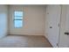 A carpeted bedroom featuring a window, baseboard trim, and a double-door closet at 3202 Timber Hawk Cir, Ocoee, FL 34761