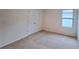 A carpeted bedroom with a window and a double-door closet at 3202 Timber Hawk Cir, Ocoee, FL 34761