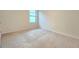 A bright, carpeted bedroom with a window at 3202 Timber Hawk Cir, Ocoee, FL 34761