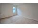 A bright, carpeted bedroom with a window offering natural light at 3202 Timber Hawk Cir, Ocoee, FL 34761