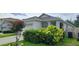 Well-maintained single Gathering home featuring a two-car garage and mature landscaping at 3202 Timber Hawk Cir, Ocoee, FL 34761