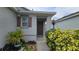 Inviting home entrance, complemented by lush plants and colorful shrubs at 3202 Timber Hawk Cir, Ocoee, FL 34761
