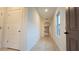 Bright hallway with neutral paint and tile floors, leading to other rooms in the house at 3202 Timber Hawk Cir, Ocoee, FL 34761