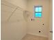 Compact laundry room with tile flooring and a small window at 3202 Timber Hawk Cir, Ocoee, FL 34761