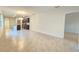 Open-concept living room featuring tile floors connecting to the kitchen with an island at 3202 Timber Hawk Cir, Ocoee, FL 34761