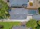 Aerial view of the house, garage and screened in pool, surrounded by green grass at 3226 Helen Ave, Orlando, FL 32804