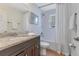 Bright bathroom with granite countertop vanity and a tiled shower and tub at 3226 Helen Ave, Orlando, FL 32804