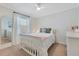 Serene bedroom with a white bed frame, soft natural light, and a side table at 3226 Helen Ave, Orlando, FL 32804