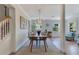 Light-filled dining room features a wooden table for four, geometric chandelier, and an adjacent staircase at 3226 Helen Ave, Orlando, FL 32804