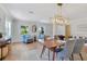Open concept dining and sitting room with floor-to-ceiling windows, accent chairs, and elegant chandelier at 3226 Helen Ave, Orlando, FL 32804