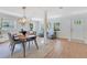 Dining area flows from a sitting area and features a modern light fixture and stylish table setting at 3226 Helen Ave, Orlando, FL 32804