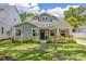 Charming craftsman home features a lush, green lawn and manicured landscaping around the front at 3226 Helen Ave, Orlando, FL 32804