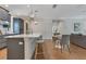 Spacious kitchen with bar seating, modern lighting, and a seamless transition to the living areas at 3226 Helen Ave, Orlando, FL 32804
