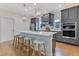 Stylish kitchen boasts gray cabinets, stainless steel appliances, white countertops, and a breakfast bar with seating at 3226 Helen Ave, Orlando, FL 32804