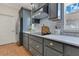 A well-equipped kitchen with gray cabinetry, stainless steel appliances, subway tile backsplash, and a modern stovetop at 3226 Helen Ave, Orlando, FL 32804