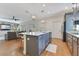 Bright, open kitchen features gray cabinets, stainless steel appliances, and a large island with seating overlooking the living area at 3226 Helen Ave, Orlando, FL 32804